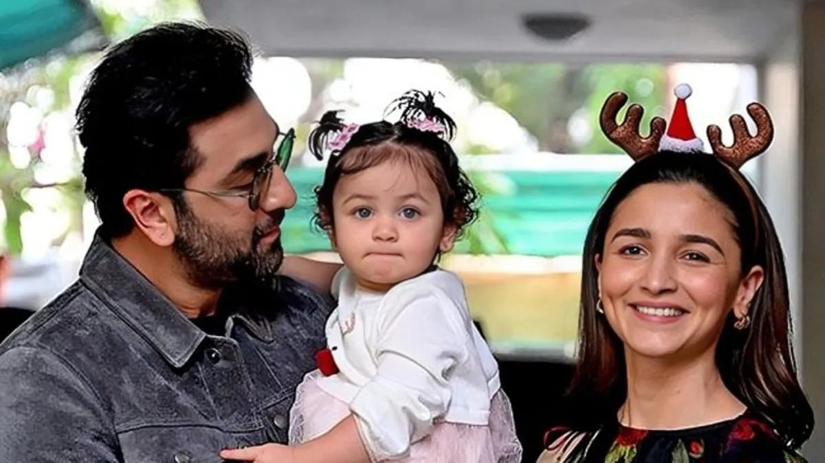 Bollywood actors Ranbir Kapoor L and his wife Alia Bhatt pose with their daughter Raha upon their